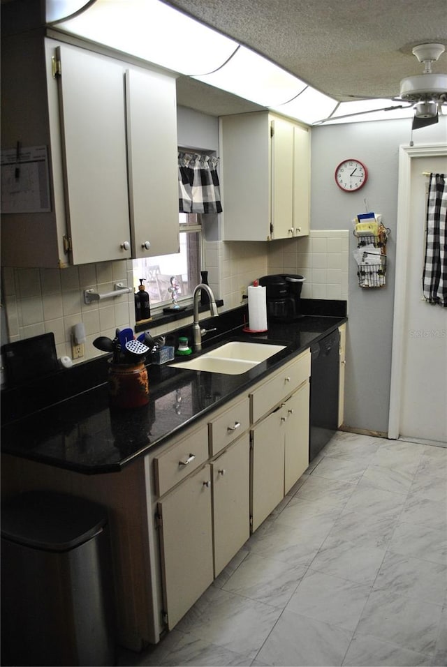 kitchen featuring tasteful backsplash, black dishwasher, a textured ceiling, ceiling fan, and sink