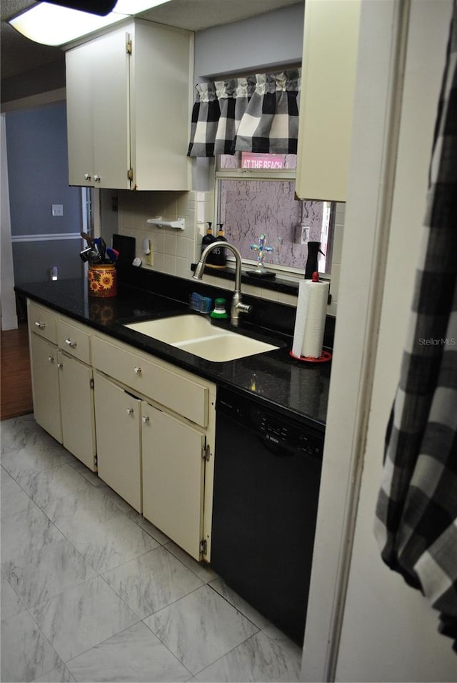 kitchen featuring dishwasher, sink, and decorative backsplash