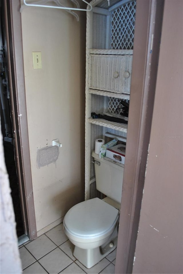 bathroom featuring toilet and tile patterned floors