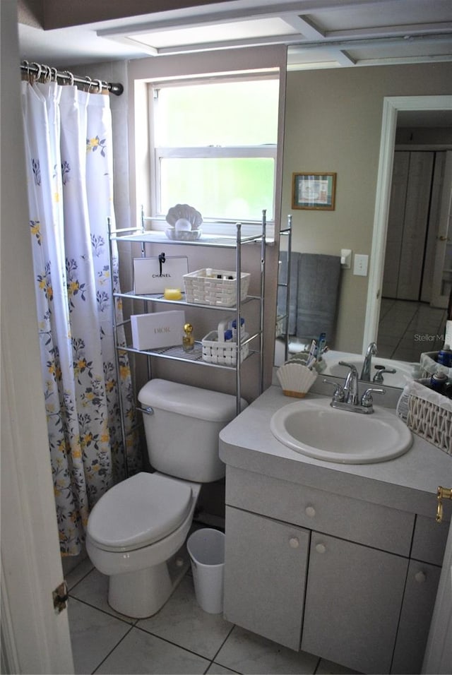 bathroom featuring tile patterned flooring, curtained shower, vanity, and toilet