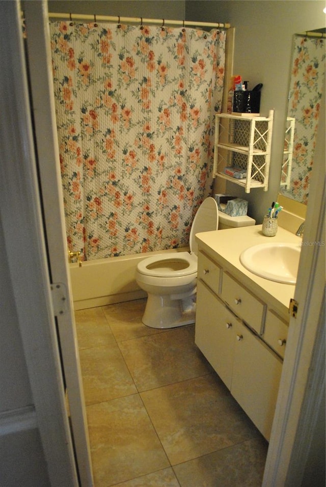 full bathroom featuring shower / bath combination with curtain, vanity, toilet, and tile patterned floors