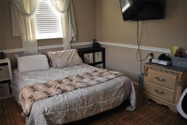 bedroom with dark parquet flooring