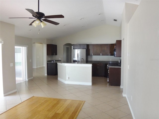 kitchen featuring dark brown cabinets, an island with sink, lofted ceiling, stainless steel appliances, and ceiling fan