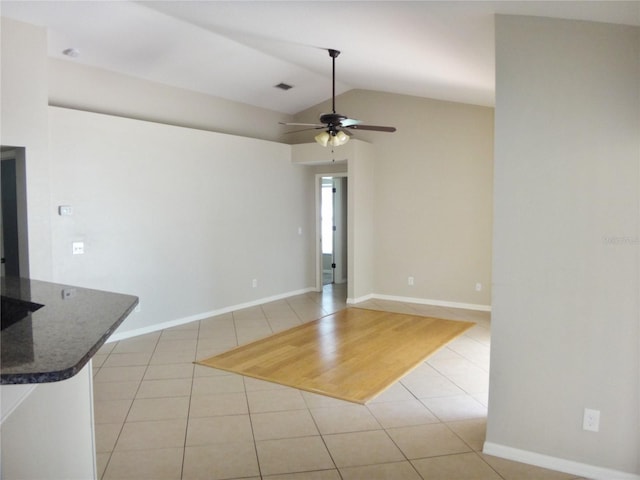 unfurnished room with ceiling fan, light tile patterned flooring, and lofted ceiling