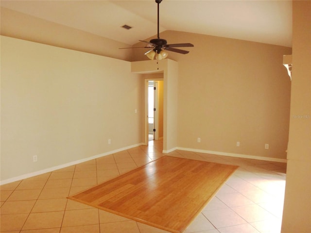 tiled empty room featuring ceiling fan and lofted ceiling