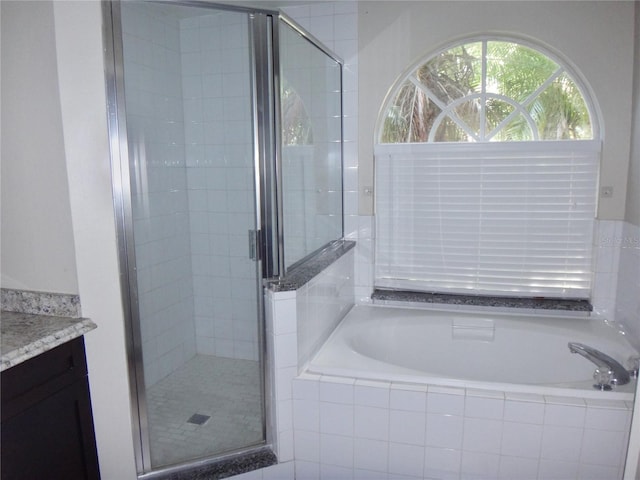 bathroom featuring vanity and separate shower and tub