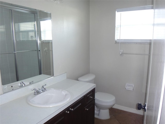 bathroom with tile patterned floors, an enclosed shower, vanity, and toilet