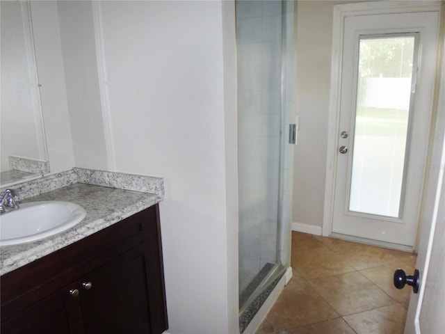 bathroom with vanity, tile patterned floors, and a shower with shower door