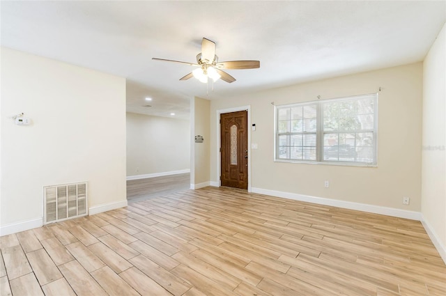 spare room with light wood-type flooring and ceiling fan