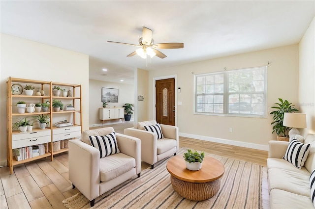 living room featuring light hardwood / wood-style floors and ceiling fan