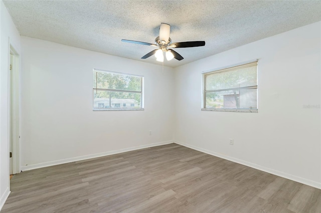 unfurnished room featuring a textured ceiling, wood-type flooring, and ceiling fan