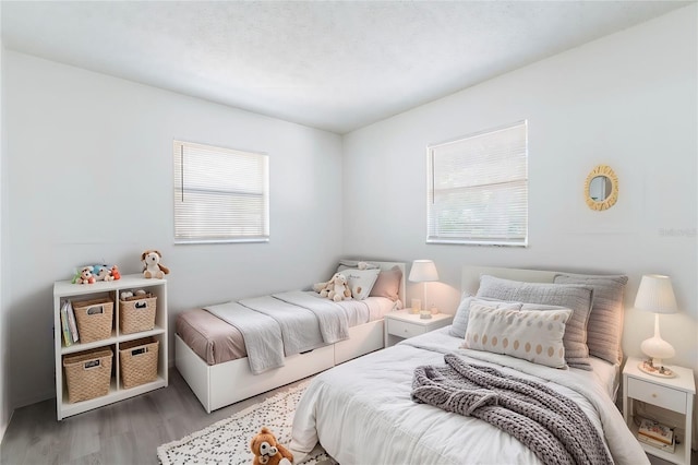 bedroom featuring light hardwood / wood-style floors and multiple windows