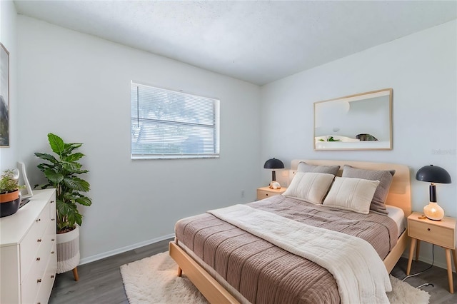 bedroom with dark wood-type flooring