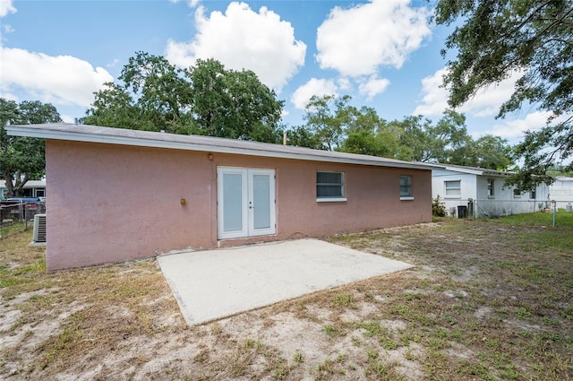 rear view of property with french doors and a patio area