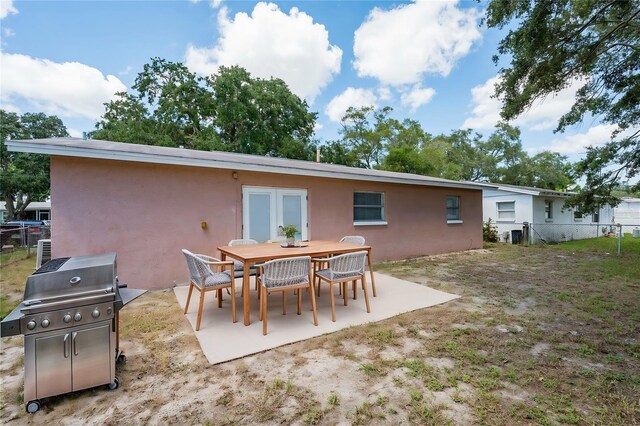 rear view of property with a patio area and french doors