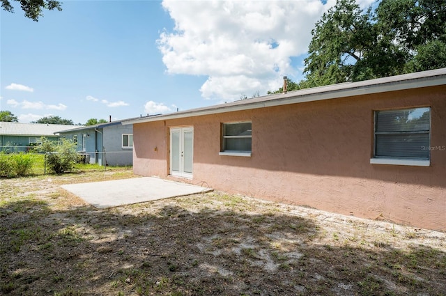 rear view of property featuring a patio area