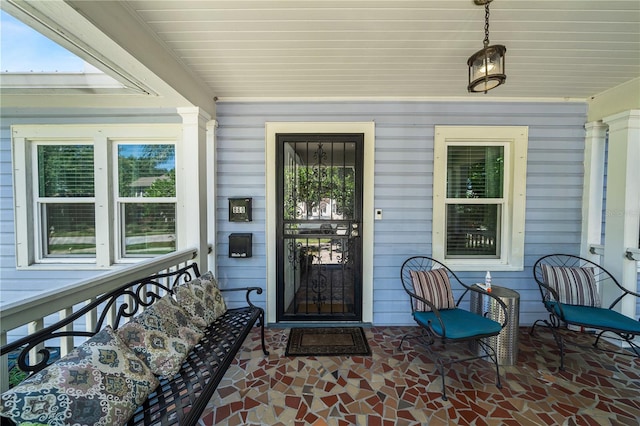 view of exterior entry featuring a porch