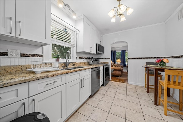 kitchen featuring appliances with stainless steel finishes, crown molding, sink, and white cabinetry