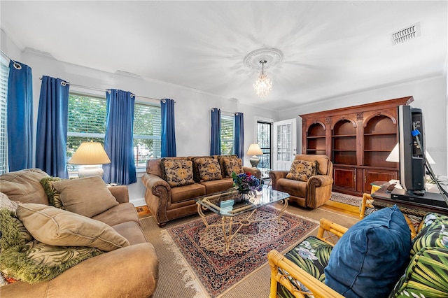 living room with ornamental molding and an inviting chandelier