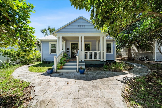 view of front of property featuring covered porch and metal roof