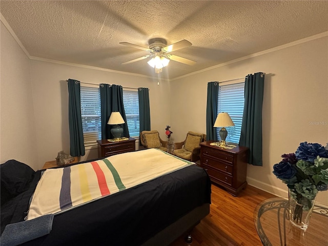 bedroom with a ceiling fan, crown molding, wood finished floors, and a textured ceiling