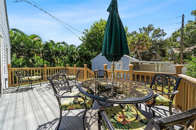 wooden terrace with outdoor dining area