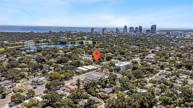 birds eye view of property with a view of city and a water view