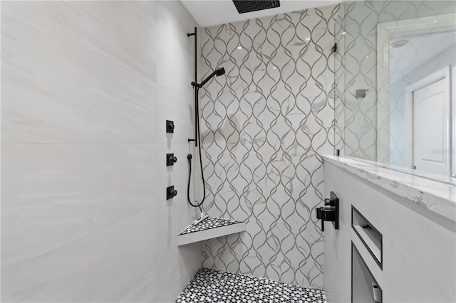 bathroom with tiled shower