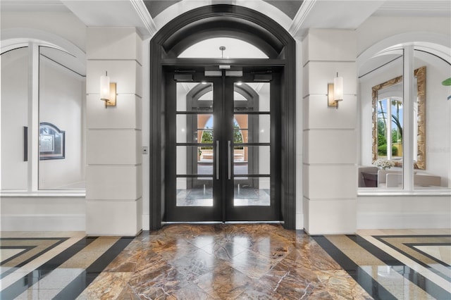 foyer featuring french doors and crown molding