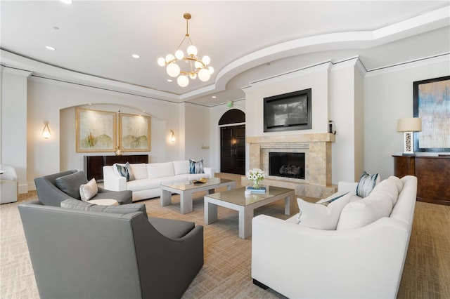 living room with a premium fireplace, crown molding, light colored carpet, and a chandelier