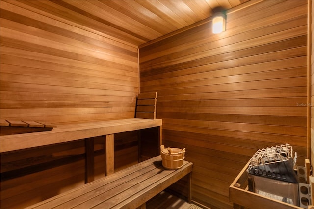 view of sauna / steam room with wooden walls and wood ceiling