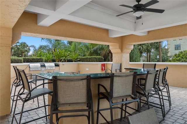 view of patio featuring exterior kitchen, an outdoor bar, and ceiling fan