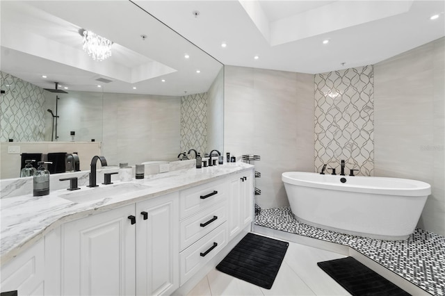 bathroom featuring tile patterned floors, plus walk in shower, a raised ceiling, tile walls, and vanity