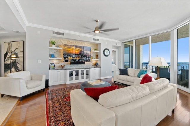 living room featuring crown molding, a wall of windows, wood-type flooring, and ceiling fan