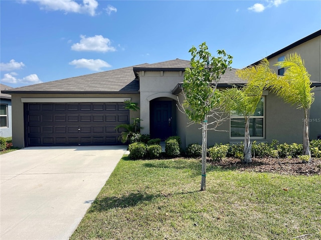 view of front facade with a front yard and a garage