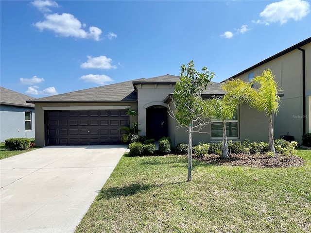 view of front of home with a front yard and a garage