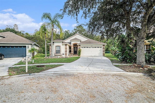 ranch-style home featuring a garage and a front lawn