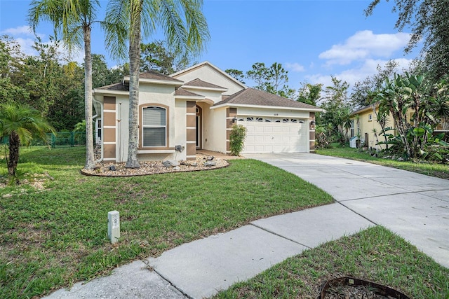 view of front of home with a front yard and a garage