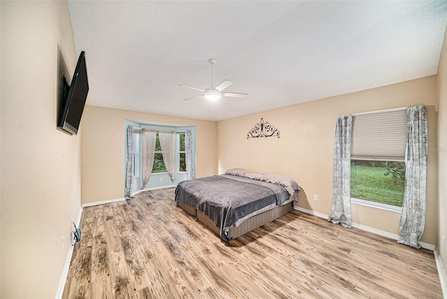 bedroom with ceiling fan and light hardwood / wood-style flooring