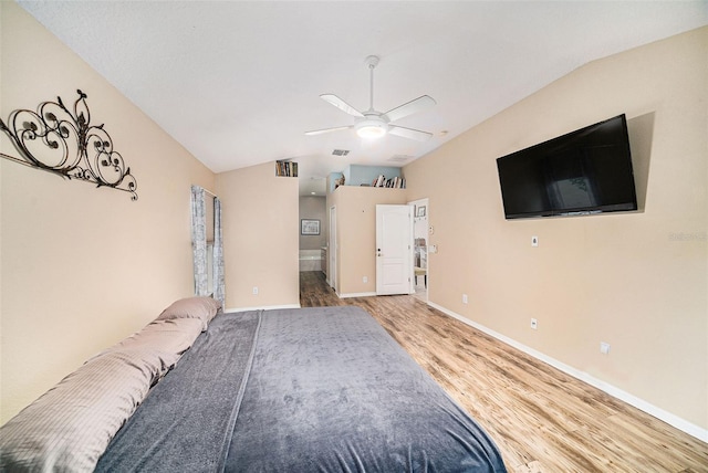 unfurnished bedroom with ceiling fan, vaulted ceiling, and wood-type flooring