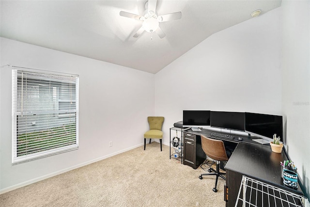 carpeted office space featuring vaulted ceiling and ceiling fan