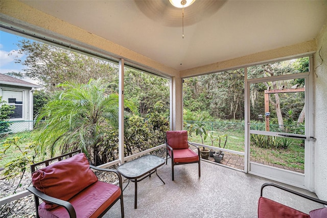 sunroom featuring ceiling fan