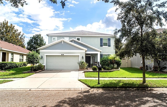 view of front of property featuring a front yard and a garage