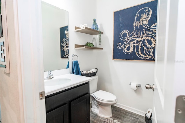 bathroom featuring vanity, hardwood / wood-style flooring, and toilet