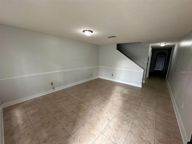 spare room featuring a textured ceiling