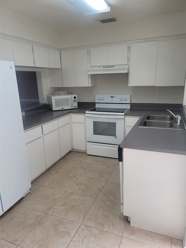 kitchen featuring white cabinets, white appliances, a textured ceiling, and sink