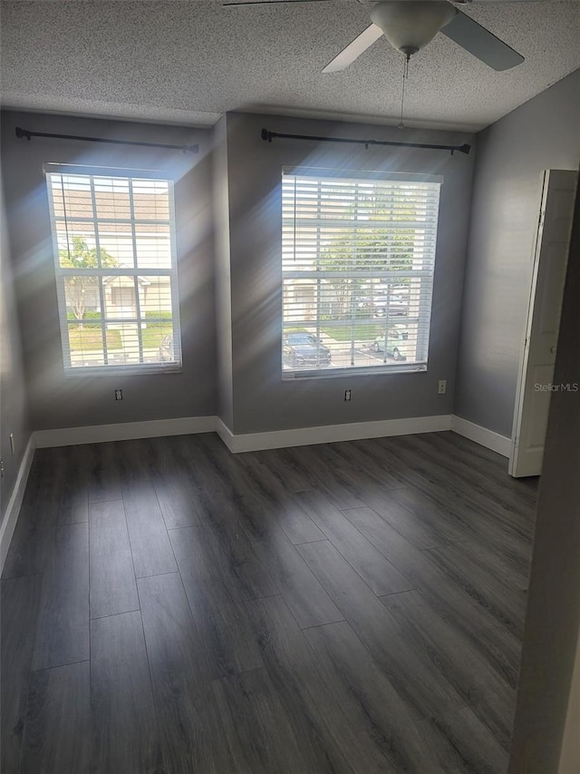 unfurnished dining area with a textured ceiling, ceiling fan, and dark wood-type flooring