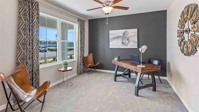 carpeted office space with ceiling fan