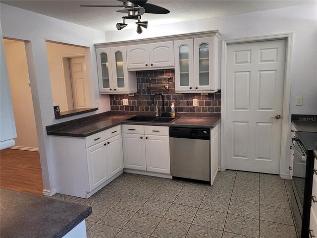 10908 Claymont Dr, New Port Richey, FL 34654 - kitchen with dishwasher, a sink, dark countertops, ceiling fan, and backsplash