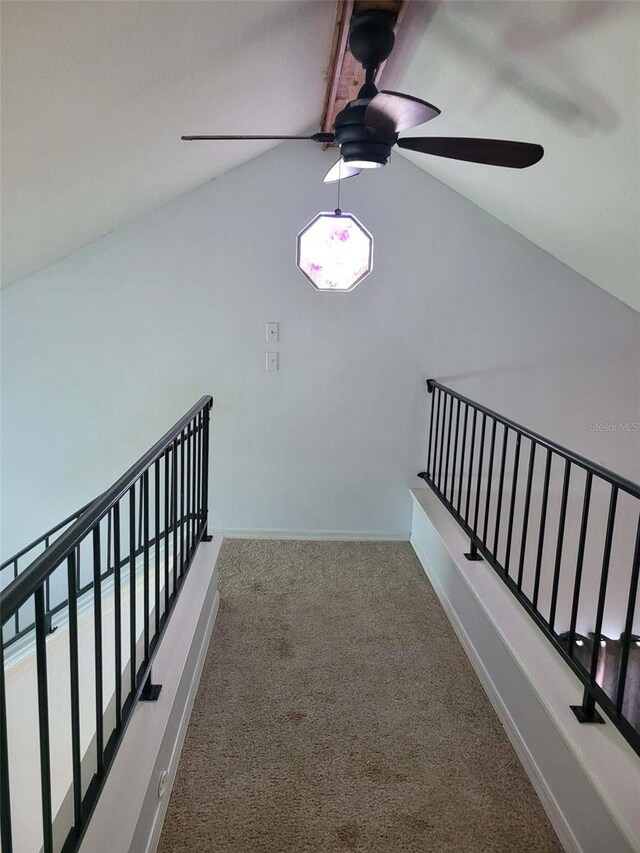 10908 Claymont Dr, New Port Richey, FL 34654 - stairway with a ceiling fan, carpet floors, baseboards, and vaulted ceiling